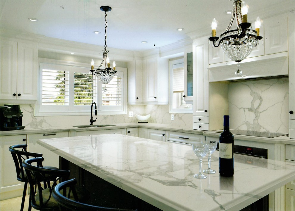 Photo of a large modern l-shaped kitchen/diner in Miami with a double-bowl sink, raised-panel cabinets, white cabinets, black appliances, porcelain flooring, an island and beige floors.
