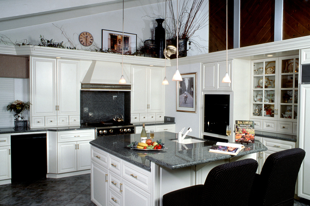 Klassisk inredning av ett mellanstort kök, med en undermonterad diskho, luckor med upphöjd panel, vita skåp, laminatbänkskiva, grått stänkskydd, stänkskydd i sten, rostfria vitvaror, heltäckningsmatta, en köksö och vitt golv