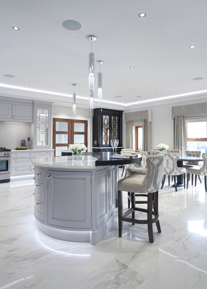 Inspiration for a mid-sized contemporary l-shaped marble floor open concept kitchen remodel in Belfast with an integrated sink, beaded inset cabinets, gray cabinets, quartzite countertops, white backsplash, stone slab backsplash, stainless steel appliances and an island
