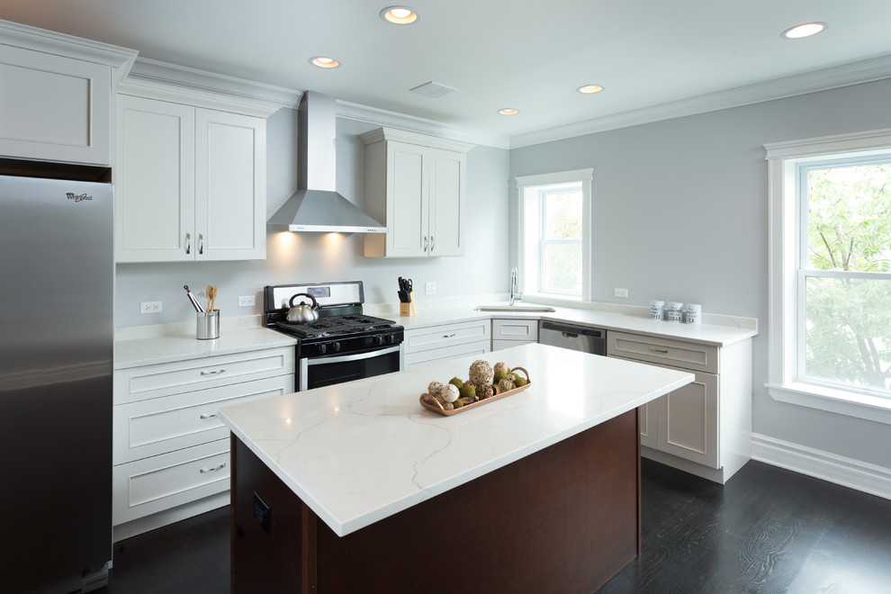 Example of a mid-sized trendy l-shaped dark wood floor open concept kitchen design in Chicago with an undermount sink, flat-panel cabinets, white cabinets, quartz countertops, white backsplash, stainless steel appliances and an island