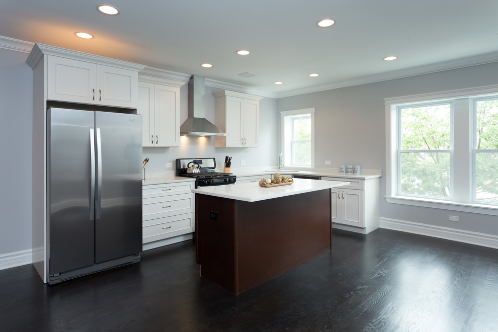 Mid-sized trendy l-shaped dark wood floor open concept kitchen photo in Chicago with an undermount sink, flat-panel cabinets, white cabinets, quartz countertops, white backsplash, stainless steel appliances and an island