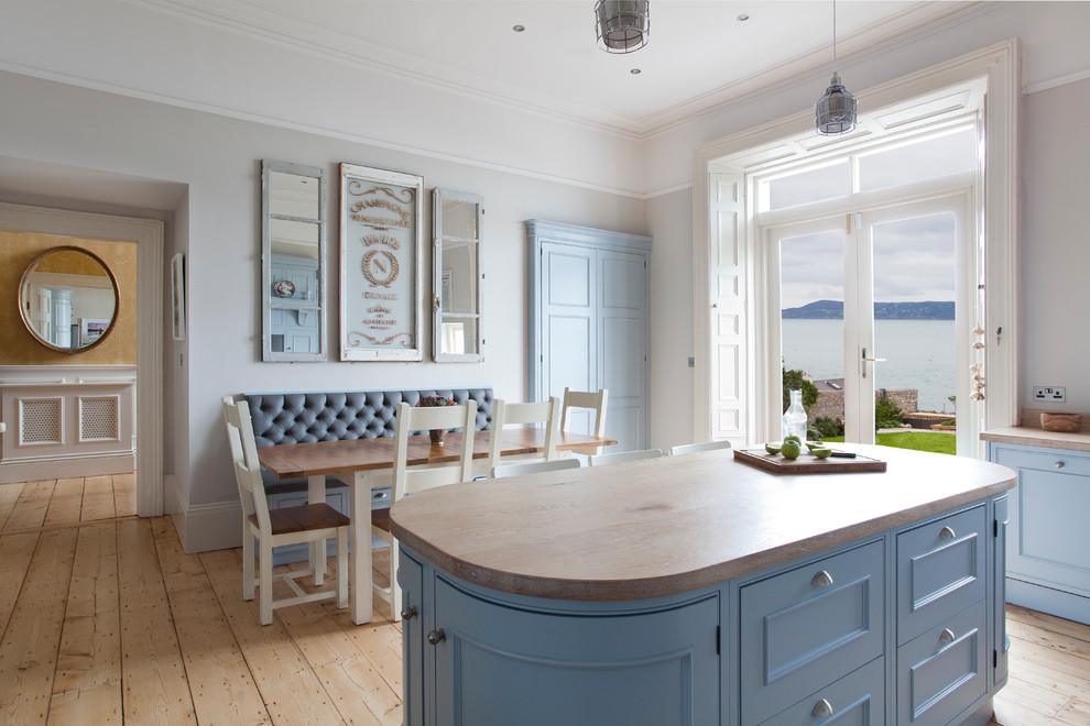 Rural l-shaped kitchen in Dublin with shaker cabinets and an island.