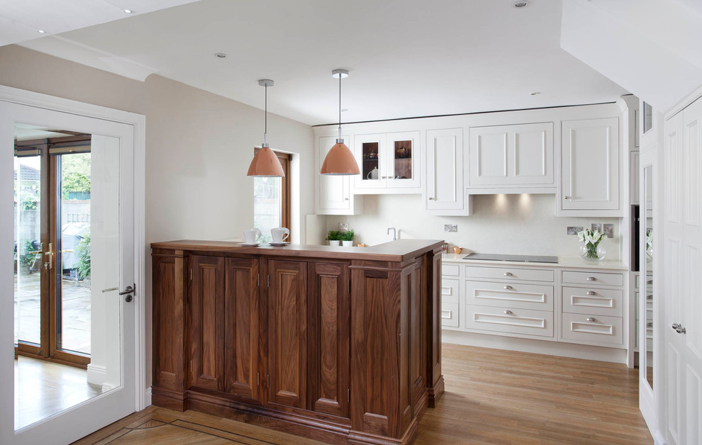 Kitchen - small transitional single-wall light wood floor and beige floor kitchen idea in Dublin with recessed-panel cabinets, white cabinets and a peninsula