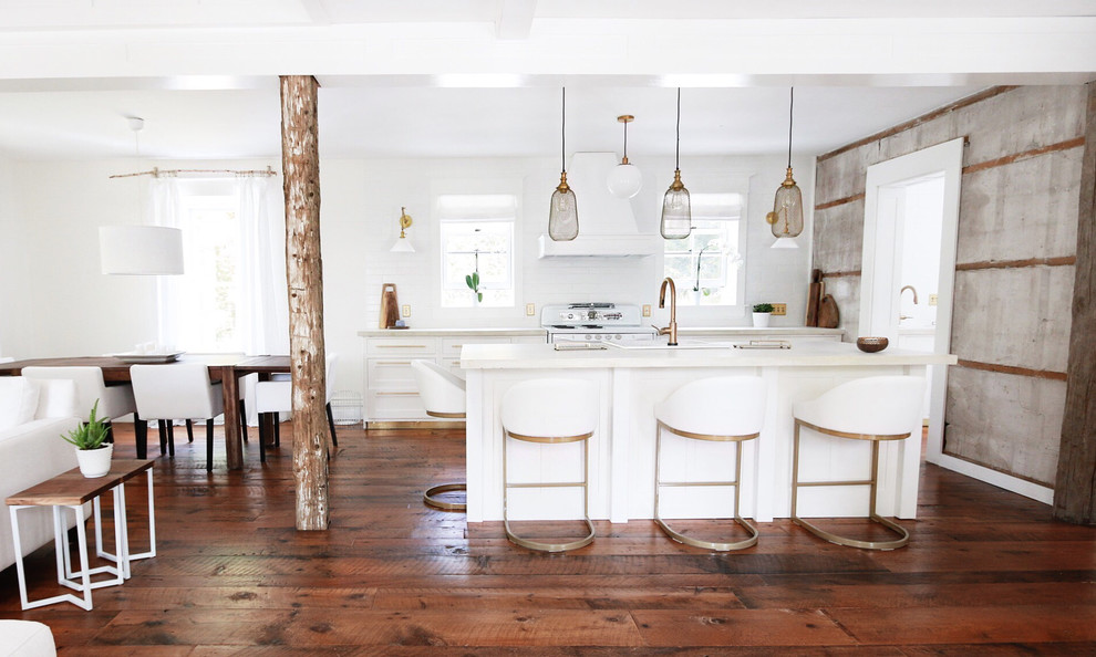 Large cottage single-wall medium tone wood floor eat-in kitchen photo in Toronto with a farmhouse sink, shaker cabinets, white cabinets, concrete countertops, white backsplash, ceramic backsplash, white appliances and an island