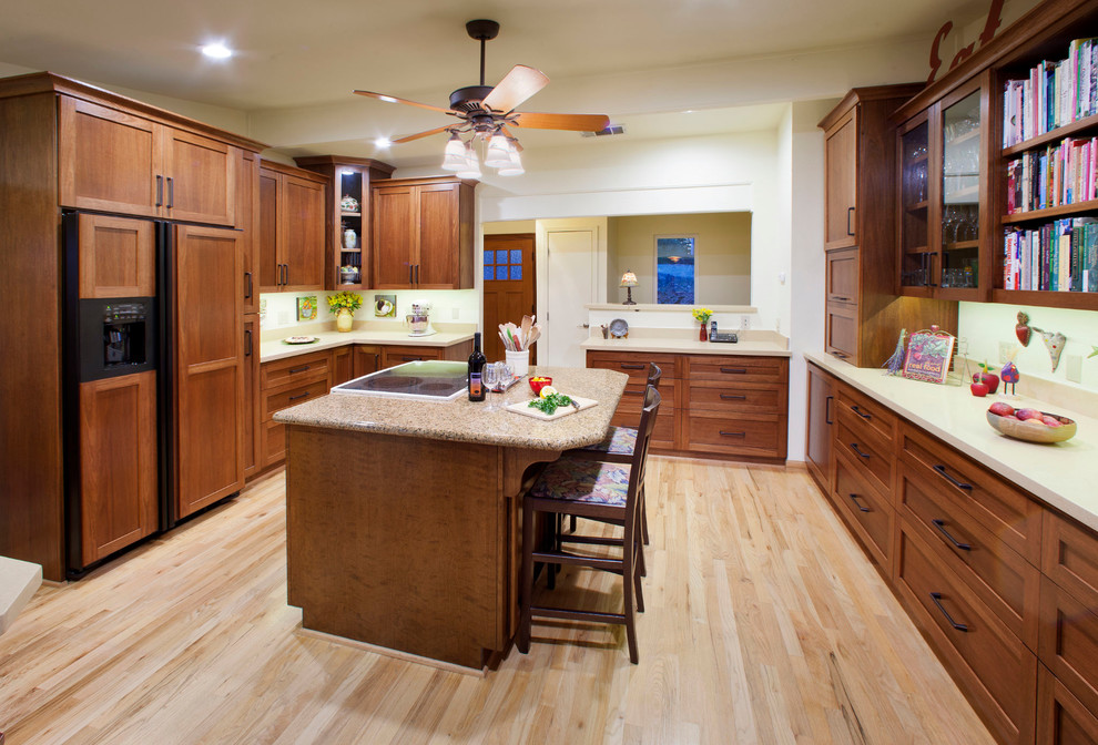 Enclosed kitchen - traditional enclosed kitchen idea in Sacramento with shaker cabinets, medium tone wood cabinets, paneled appliances and an island