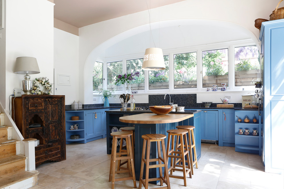 Medium sized country kitchen/diner in Kent with raised-panel cabinets, blue cabinets, wood worktops and an island.