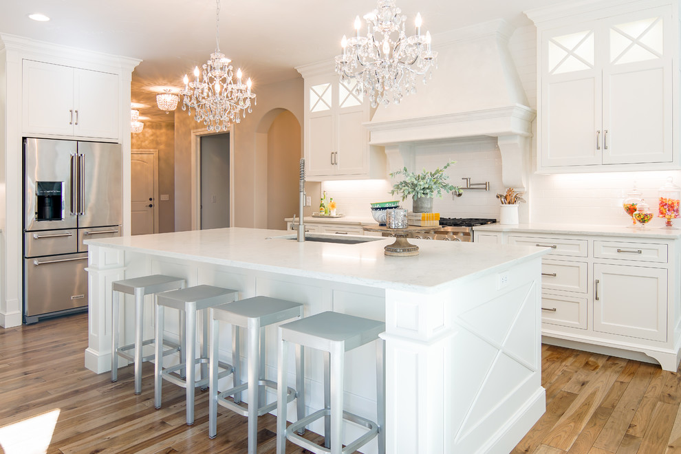 Inspiration for a timeless kitchen remodel in Cleveland with white cabinets, stainless steel appliances and an island