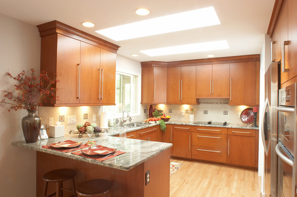 Inspiration for a contemporary u-shaped kitchen remodel in Detroit with flat-panel cabinets and medium tone wood cabinets