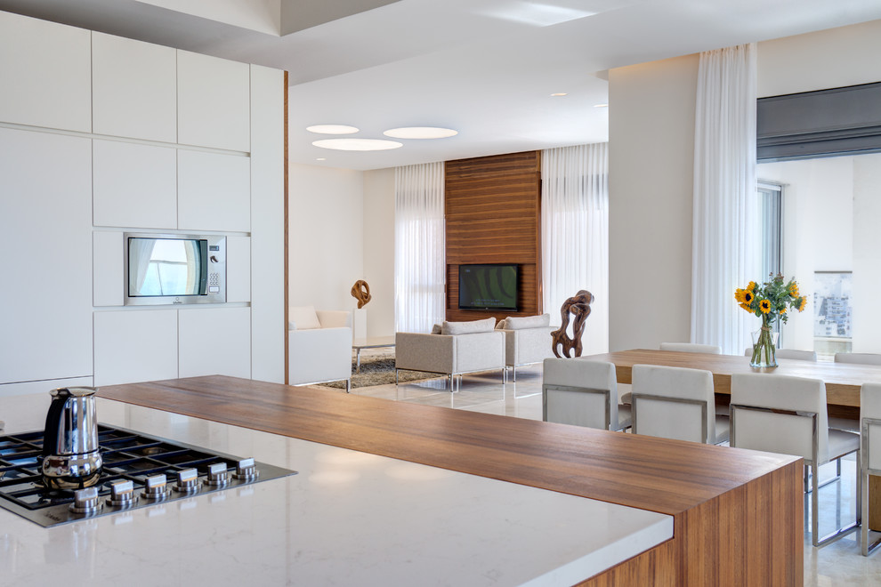 Eat-in kitchen - modern u-shaped marble floor eat-in kitchen idea in Other with flat-panel cabinets, beige cabinets, quartzite countertops, white backsplash, stainless steel appliances and an island