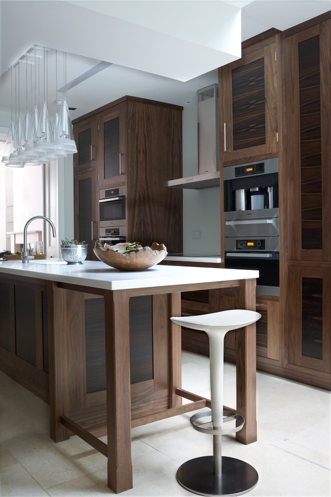 Design ideas for a large contemporary galley kitchen/diner in West Midlands with a submerged sink, recessed-panel cabinets, dark wood cabinets, wood worktops, white splashback, glass sheet splashback, stainless steel appliances, ceramic flooring and an island.