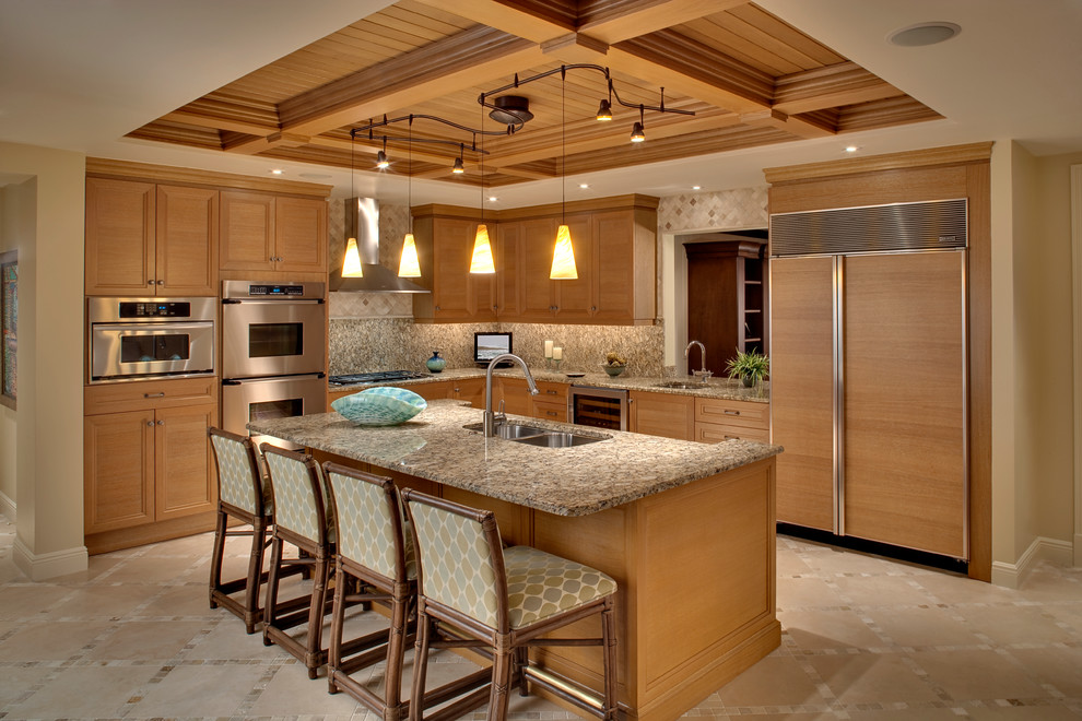 World-inspired u-shaped kitchen/diner in Miami with a double-bowl sink, recessed-panel cabinets, medium wood cabinets, multi-coloured splashback, integrated appliances, granite worktops, stone slab splashback, porcelain flooring and an island.