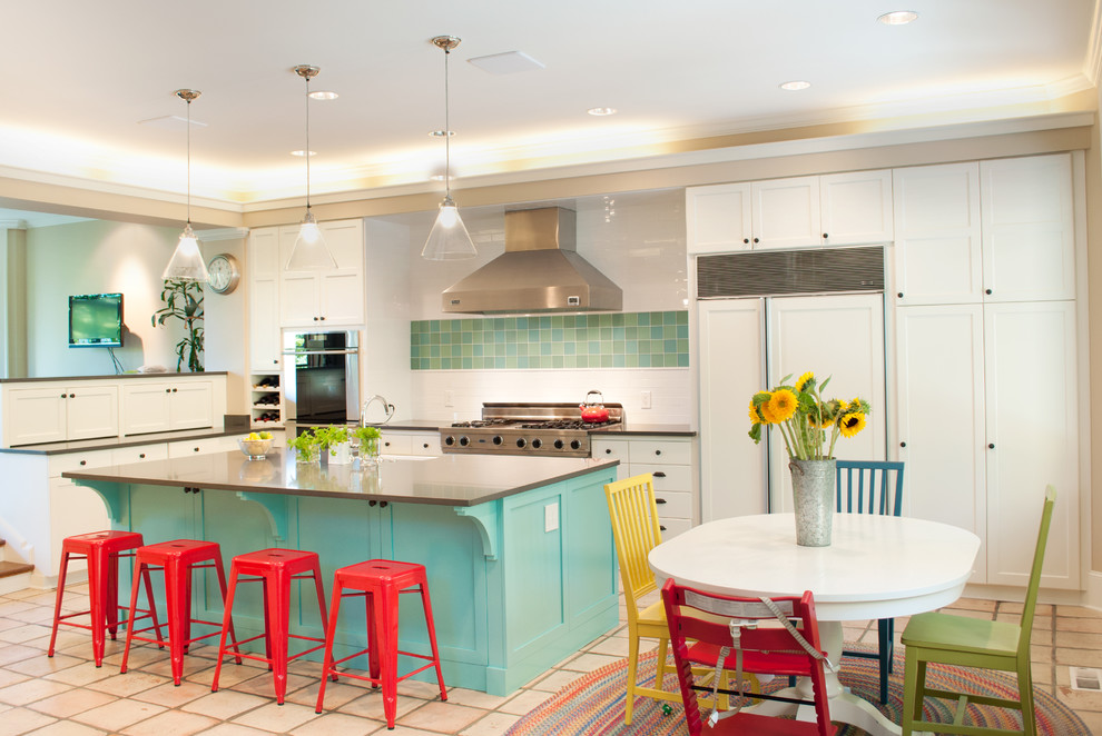 Eat-in kitchen - large modern u-shaped terra-cotta tile and beige floor eat-in kitchen idea in Seattle with white cabinets, stainless steel appliances, a farmhouse sink, raised-panel cabinets, solid surface countertops, white backsplash, subway tile backsplash and an island