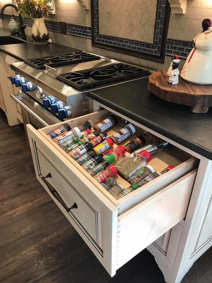 This is an example of a medium sized rural l-shaped kitchen/diner in Other with a belfast sink, distressed cabinets, stainless steel appliances, raised-panel cabinets, soapstone worktops, grey splashback, ceramic splashback, dark hardwood flooring, an island and brown floors.