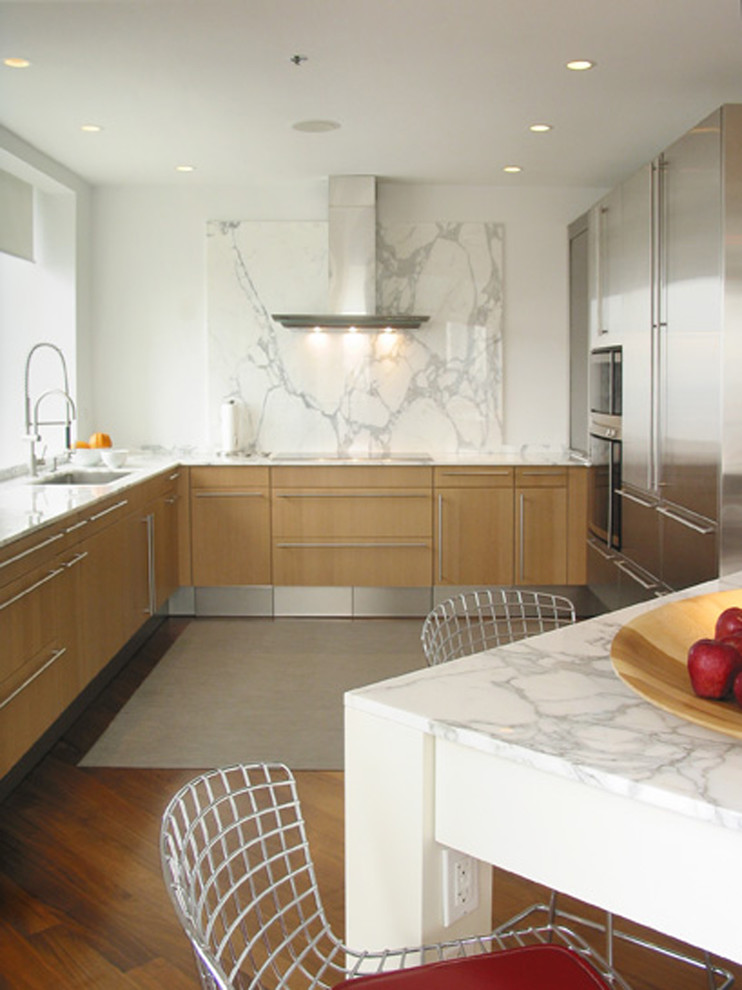 Example of a trendy kitchen design in Chicago with stainless steel appliances and marble backsplash