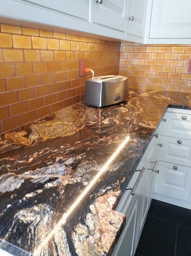 Large trendy u-shaped light wood floor eat-in kitchen photo in Other with an undermount sink, recessed-panel cabinets, light wood cabinets, granite countertops, white backsplash, ceramic backsplash, stainless steel appliances, an island and multicolored countertops