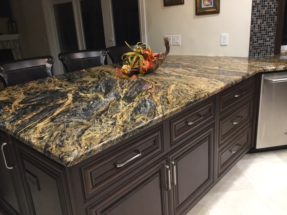Example of a trendy u-shaped marble floor kitchen design in Miami with an undermount sink, dark wood cabinets, mosaic tile backsplash and stainless steel appliances