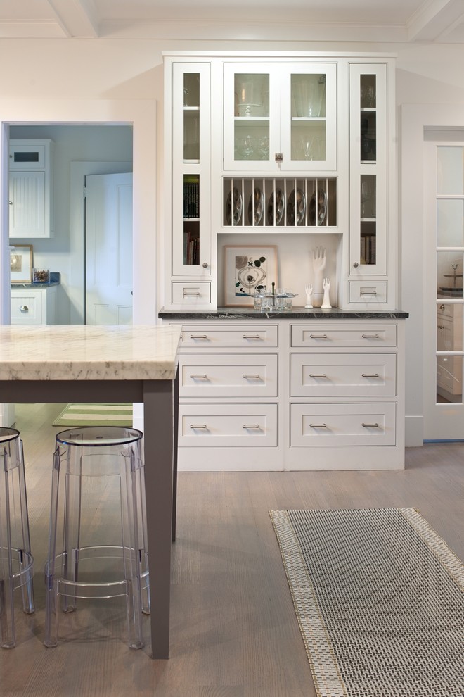 Photo of a traditional kitchen in New York with beaded cabinets and white cabinets.