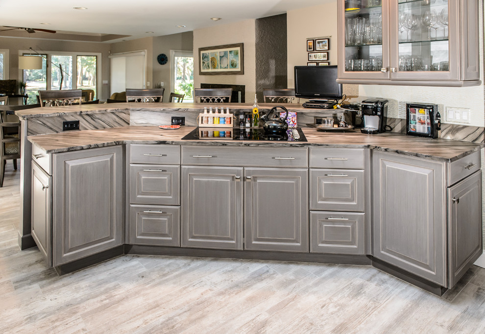 Large transitional single-wall porcelain tile eat-in kitchen photo in Charleston with louvered cabinets, gray cabinets, quartzite countertops, multicolored backsplash and black appliances