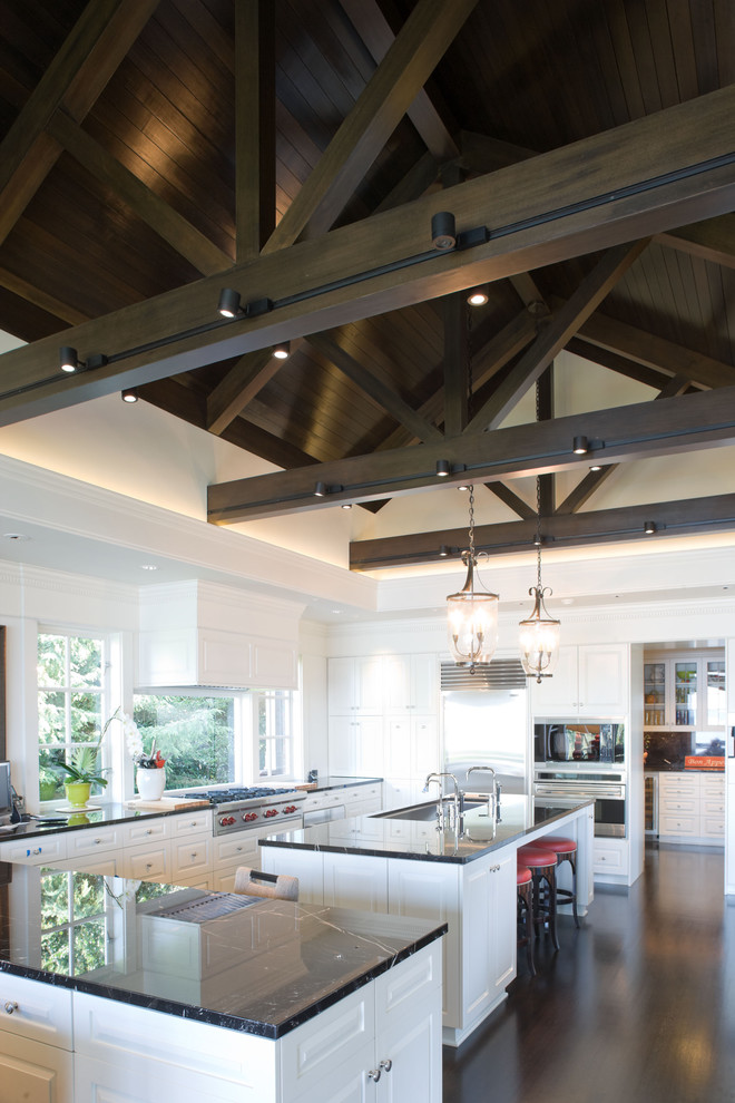 Contemporary l-shaped kitchen/diner in Seattle with stainless steel appliances, raised-panel cabinets, white cabinets, marble worktops and a submerged sink.