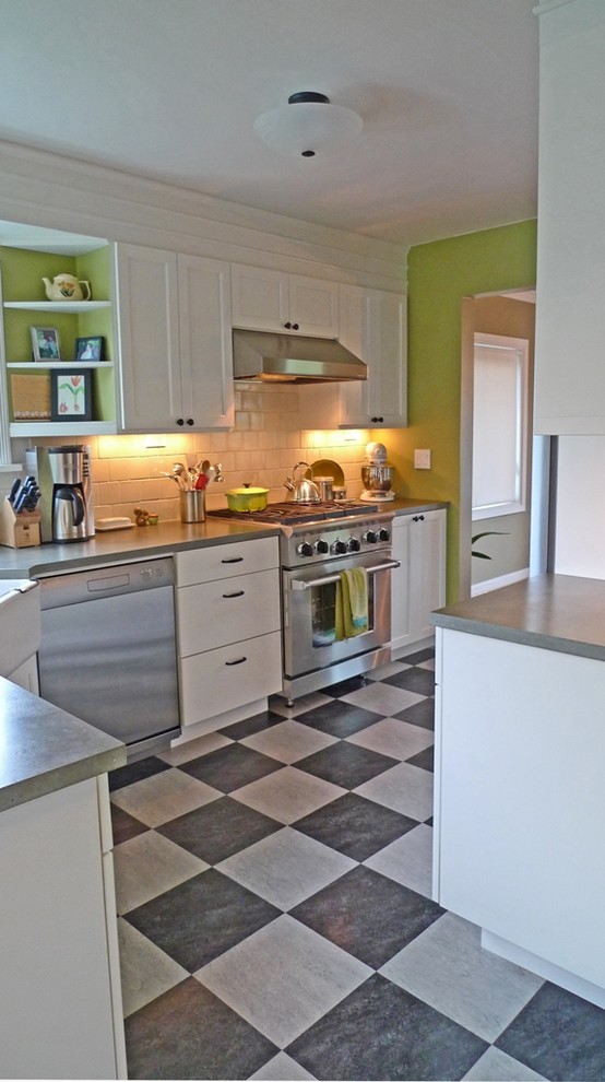 Bohemian kitchen/diner in Seattle with a belfast sink, shaker cabinets, white cabinets, composite countertops, green splashback, ceramic splashback and stainless steel appliances.