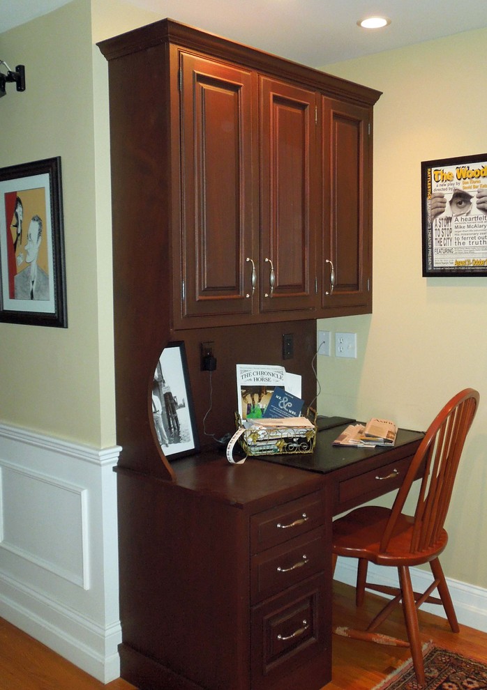 Example of a large country u-shaped medium tone wood floor enclosed kitchen design in Boston with beaded inset cabinets, dark wood cabinets, wood countertops and an island