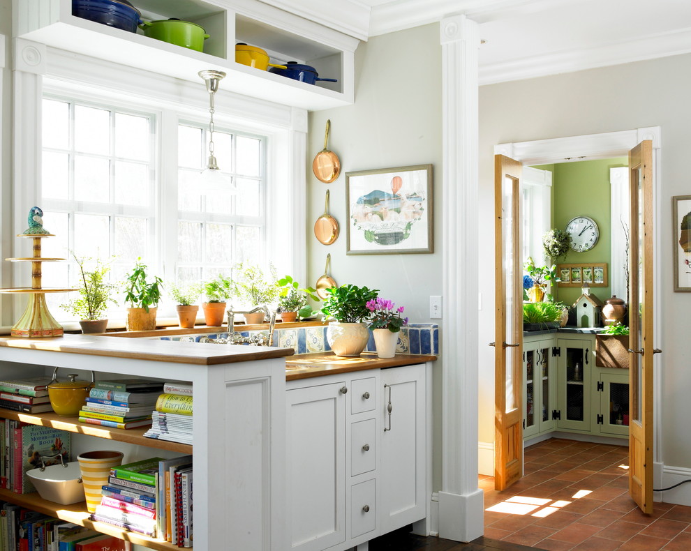 Landhaus Küche mit Schrankfronten im Shaker-Stil, weißen Schränken, Arbeitsplatte aus Holz, bunter Rückwand und Terrakottaboden in New York