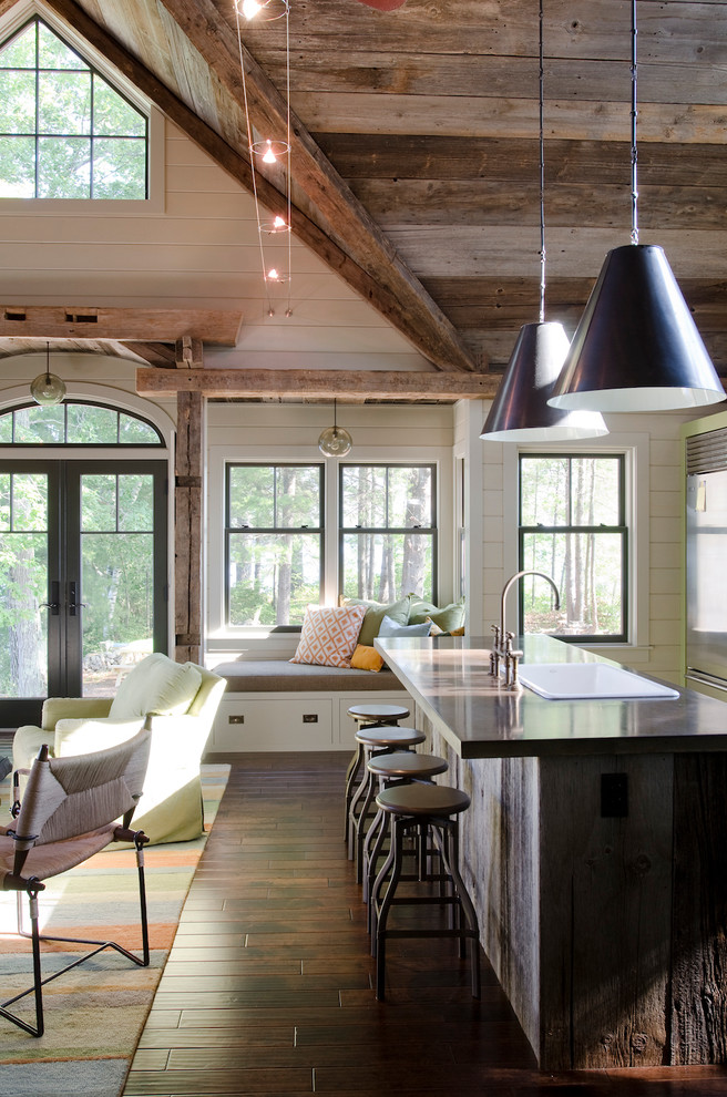 Example of a large trendy l-shaped dark wood floor eat-in kitchen design in Boston with a single-bowl sink, recessed-panel cabinets, green cabinets, solid surface countertops, stainless steel appliances and an island