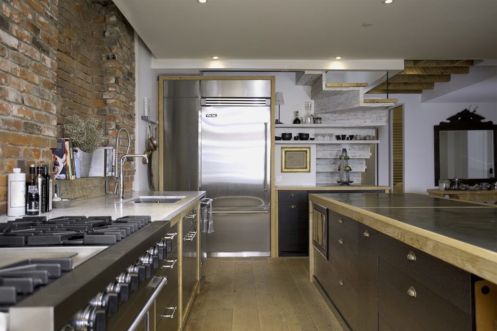 Inspiration for a medium sized contemporary kitchen/diner in Vancouver with a built-in sink, stainless steel cabinets, marble worktops, multi-coloured splashback, stainless steel appliances, light hardwood flooring, an island, stone tiled splashback and beige floors.