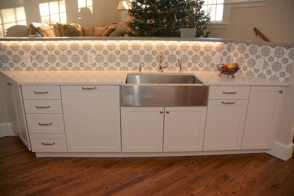 Transitional kitchen photo in New York with shaker cabinets, white cabinets, granite countertops, gray backsplash and stone tile backsplash