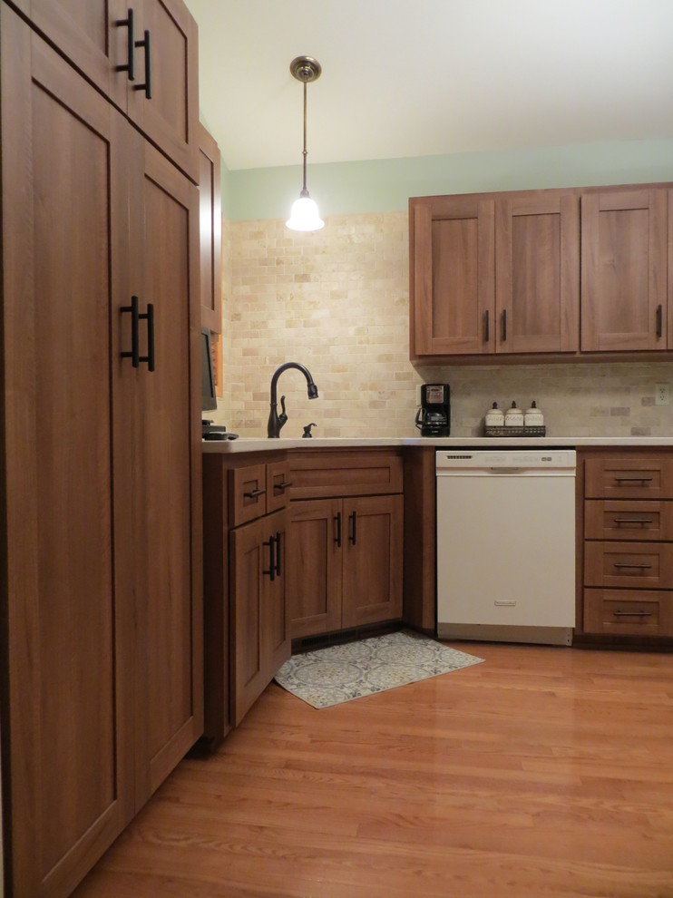 Medium sized traditional u-shaped kitchen/diner in Other with shaker cabinets, light wood cabinets and white appliances.