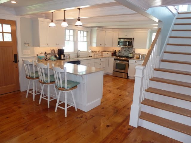 Mid-sized beach style u-shaped open concept kitchen photo in Boston with an undermount sink, shaker cabinets, white cabinets, granite countertops, multicolored backsplash, stainless steel appliances and a peninsula