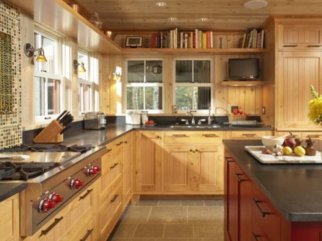Mid-sized mountain style l-shaped ceramic tile and gray floor enclosed kitchen photo in Other with a double-bowl sink, beaded inset cabinets, light wood cabinets, soapstone countertops, multicolored backsplash, mosaic tile backsplash, paneled appliances and an island