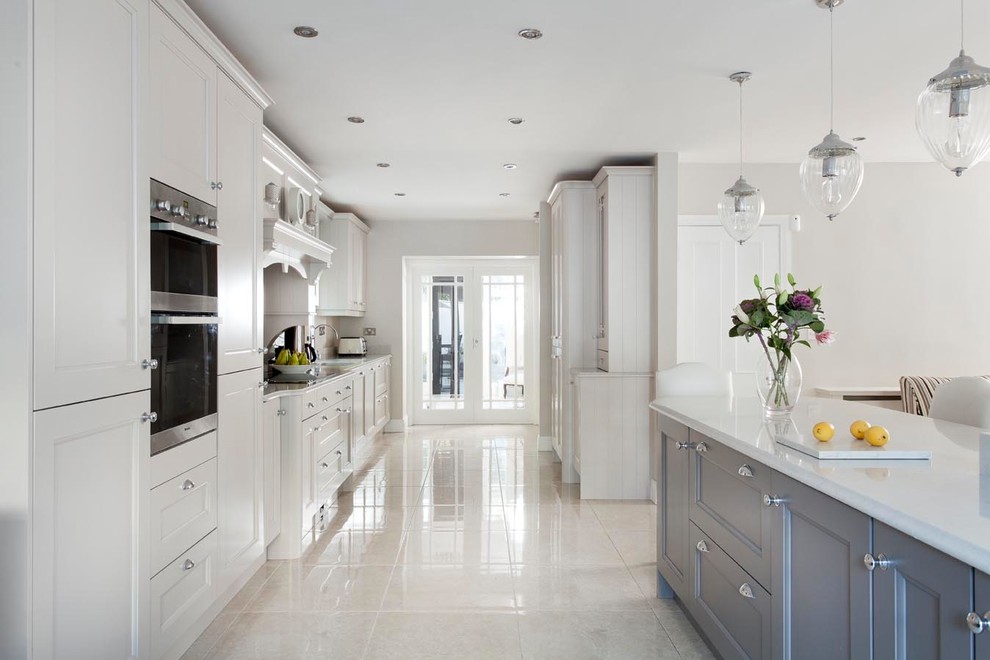 Photo of a large classic u-shaped open plan kitchen in Other with a submerged sink, beaded cabinets, grey cabinets, quartz worktops, grey splashback, stone slab splashback, stainless steel appliances, porcelain flooring, an island and grey floors.