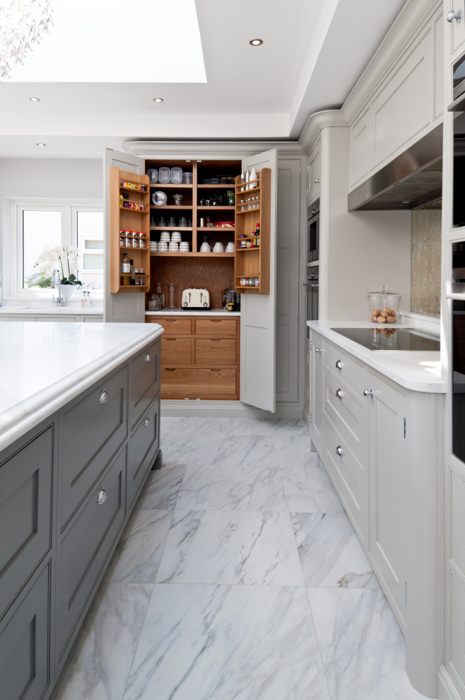 Design ideas for a large traditional kitchen/diner in Kent with beaded cabinets, grey cabinets, quartz worktops, mirror splashback, stainless steel appliances, marble flooring, an island and white worktops.