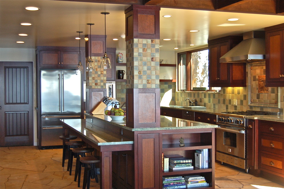 Large arts and crafts single-wall slate floor eat-in kitchen photo in Los Angeles with an undermount sink, shaker cabinets, medium tone wood cabinets, granite countertops, green backsplash, ceramic backsplash, stainless steel appliances and an island