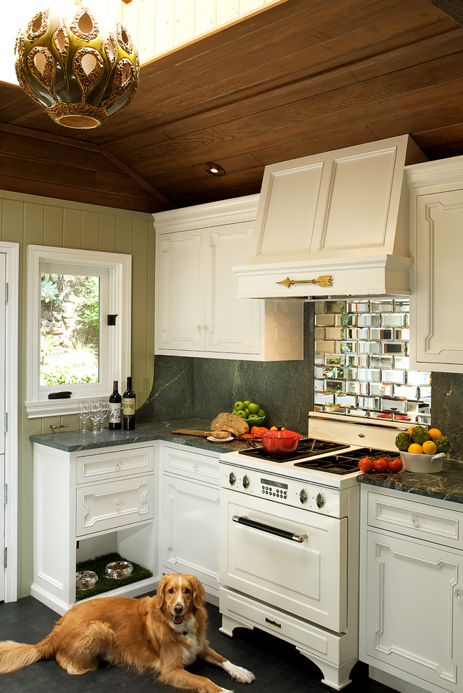 Kitchen - eclectic kitchen idea in Los Angeles with white appliances and mirror backsplash