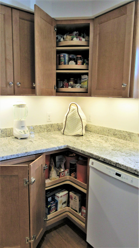 Photo of a small traditional l-shaped enclosed kitchen in Boston with a submerged sink, recessed-panel cabinets, medium wood cabinets, granite worktops, white appliances, medium hardwood flooring, no island, brown floors and multicoloured worktops.