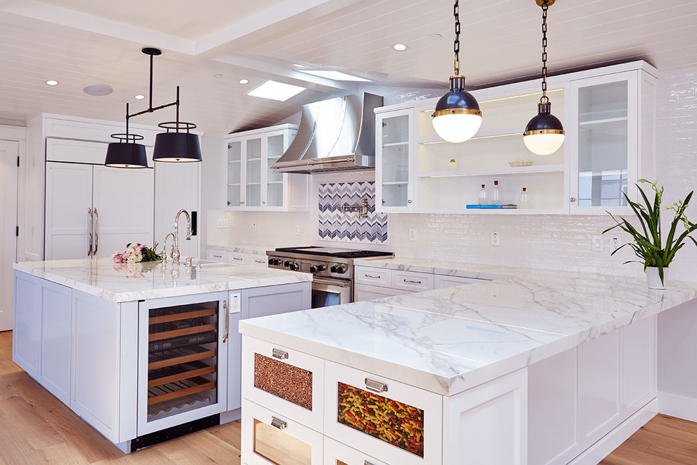 Inspiration for a large country u-shaped medium tone wood floor open concept kitchen remodel in Los Angeles with a drop-in sink, open cabinets, white cabinets, marble countertops, multicolored backsplash, an island, ceramic backsplash and paneled appliances