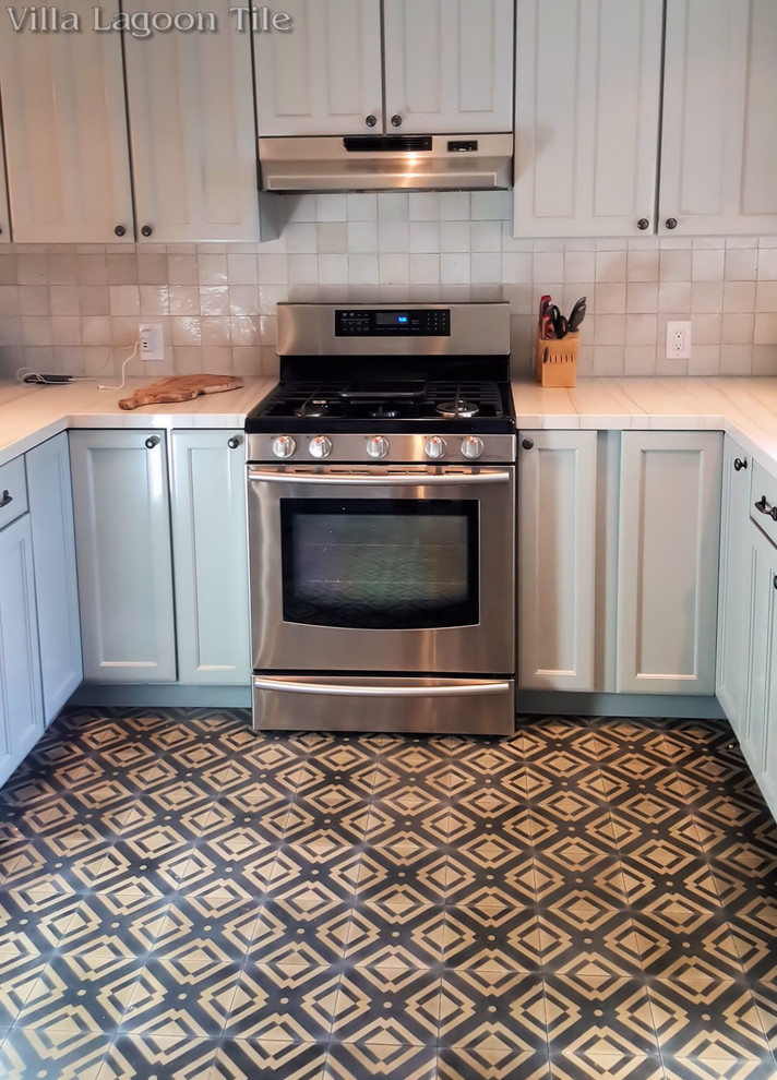 Example of an eclectic cement tile floor and black floor kitchen design
