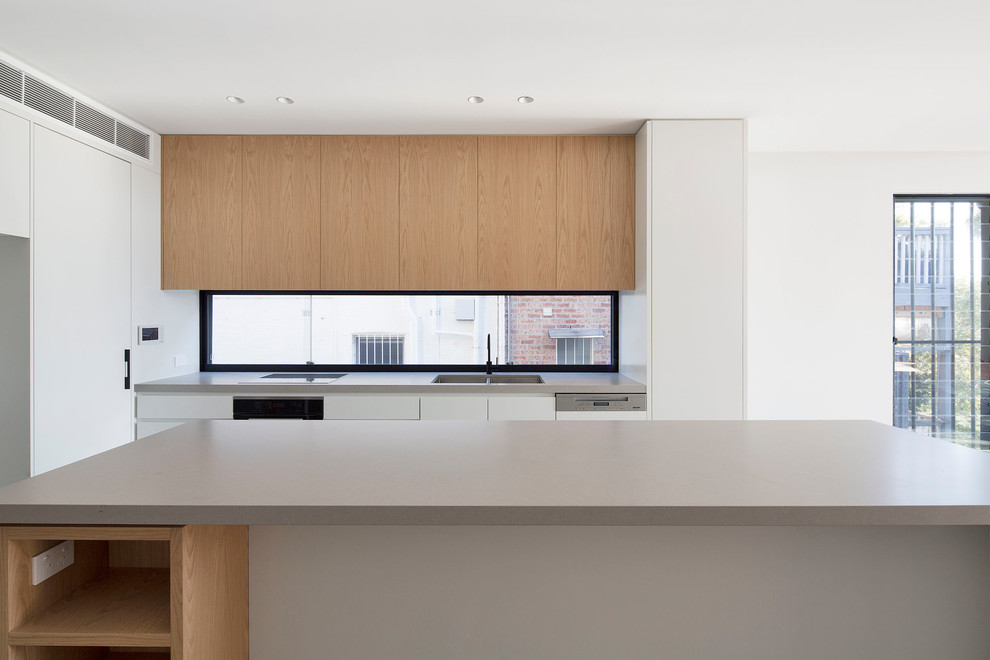 Zweizeilige, Mittelgroße Moderne Küche mit Vorratsschrank, flächenbündigen Schrankfronten, Quarzwerkstein-Arbeitsplatte, Betonboden, Kücheninsel und beiger Arbeitsplatte in Sydney