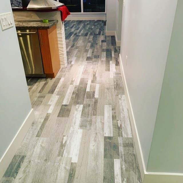 Eat-in kitchen - mid-sized contemporary u-shaped vinyl floor and gray floor eat-in kitchen idea in San Diego with flat-panel cabinets, medium tone wood cabinets, granite countertops and gray countertops