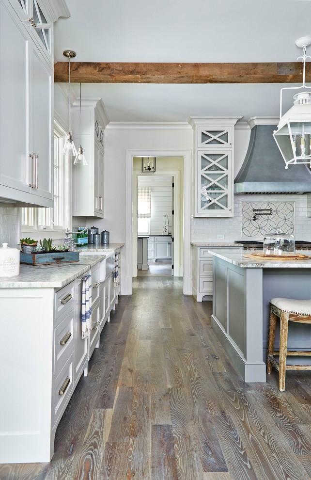 Example of a large cottage u-shaped medium tone wood floor open concept kitchen design in Atlanta with a farmhouse sink, shaker cabinets, gray cabinets, quartzite countertops, white backsplash, ceramic backsplash, stainless steel appliances and an island