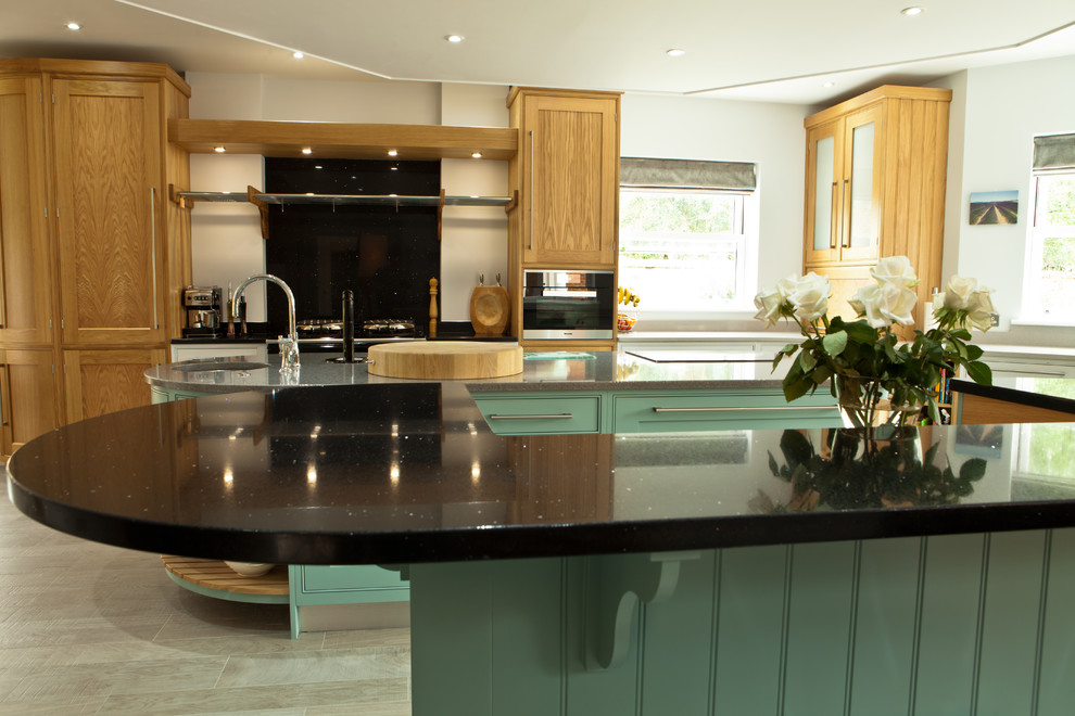 Inspiration for an expansive classic u-shaped kitchen/diner in Manchester with a double-bowl sink, shaker cabinets, quartz worktops, stainless steel appliances, ceramic flooring, multiple islands and beige floors.
