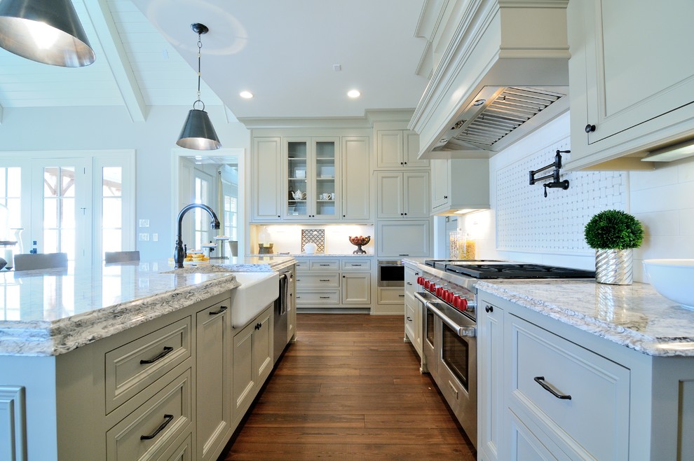Inspiration for a large contemporary l-shaped dark wood floor enclosed kitchen remodel in Atlanta with a farmhouse sink, recessed-panel cabinets, beige cabinets, granite countertops, white backsplash, mosaic tile backsplash, stainless steel appliances and an island