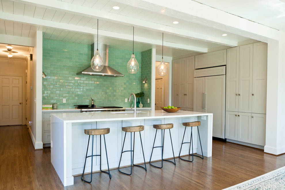 Example of a transitional single-wall eat-in kitchen design in Charlotte with beaded inset cabinets, white cabinets, green backsplash, stainless steel appliances and an island