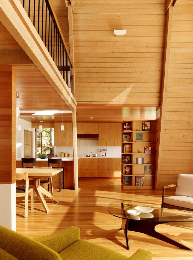 Свежая идея для дизайна: кухня-гостиная в стиле модернизм с плоскими фасадами и фасадами цвета дерева среднего тона - отличное фото интерьера