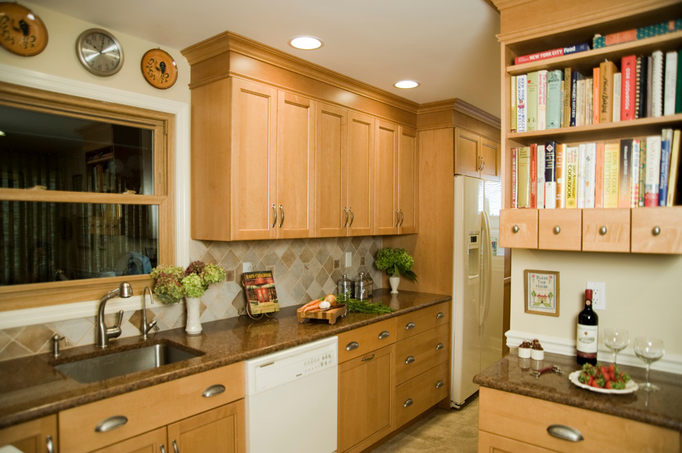 Small l-shaped linoleum floor eat-in kitchen photo in New York with an undermount sink, recessed-panel cabinets, light wood cabinets, granite countertops, multicolored backsplash, ceramic backsplash and white appliances