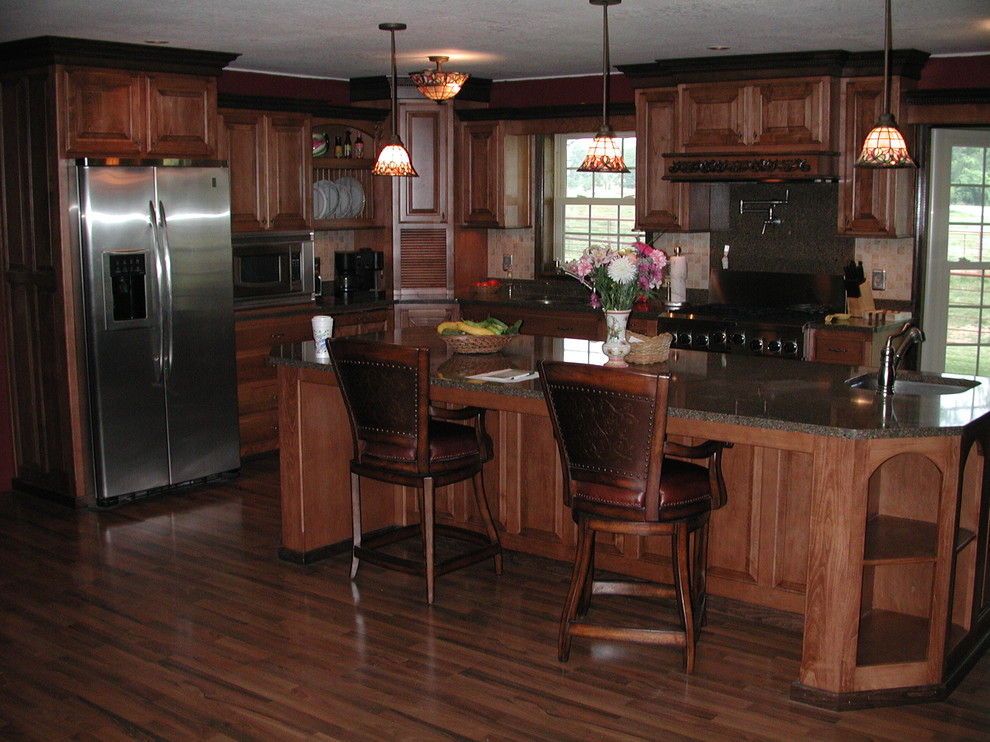 Inspiration for a timeless l-shaped dark wood floor kitchen remodel in Other with raised-panel cabinets, dark wood cabinets, granite countertops, stainless steel appliances and an island