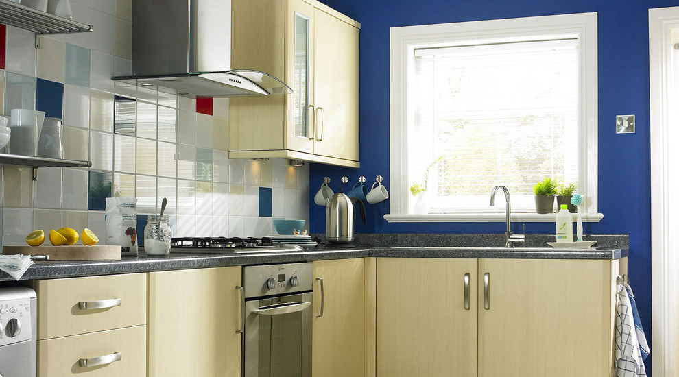 Design ideas for a contemporary kitchen in Hampshire with flat-panel cabinets, light wood cabinets and wood worktops.
