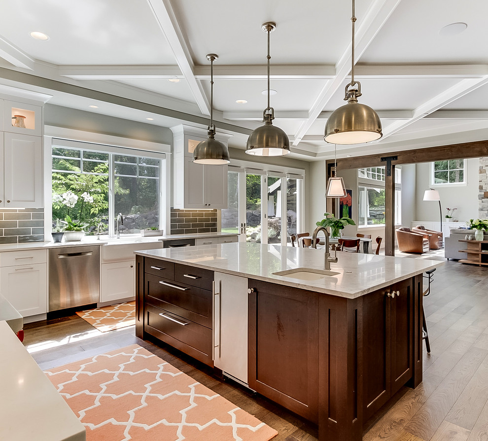 Eat-in kitchen - large traditional u-shaped dark wood floor and brown floor eat-in kitchen idea in Seattle with a farmhouse sink, shaker cabinets, white cabinets, quartz countertops, brown backsplash, porcelain backsplash, stainless steel appliances and an island